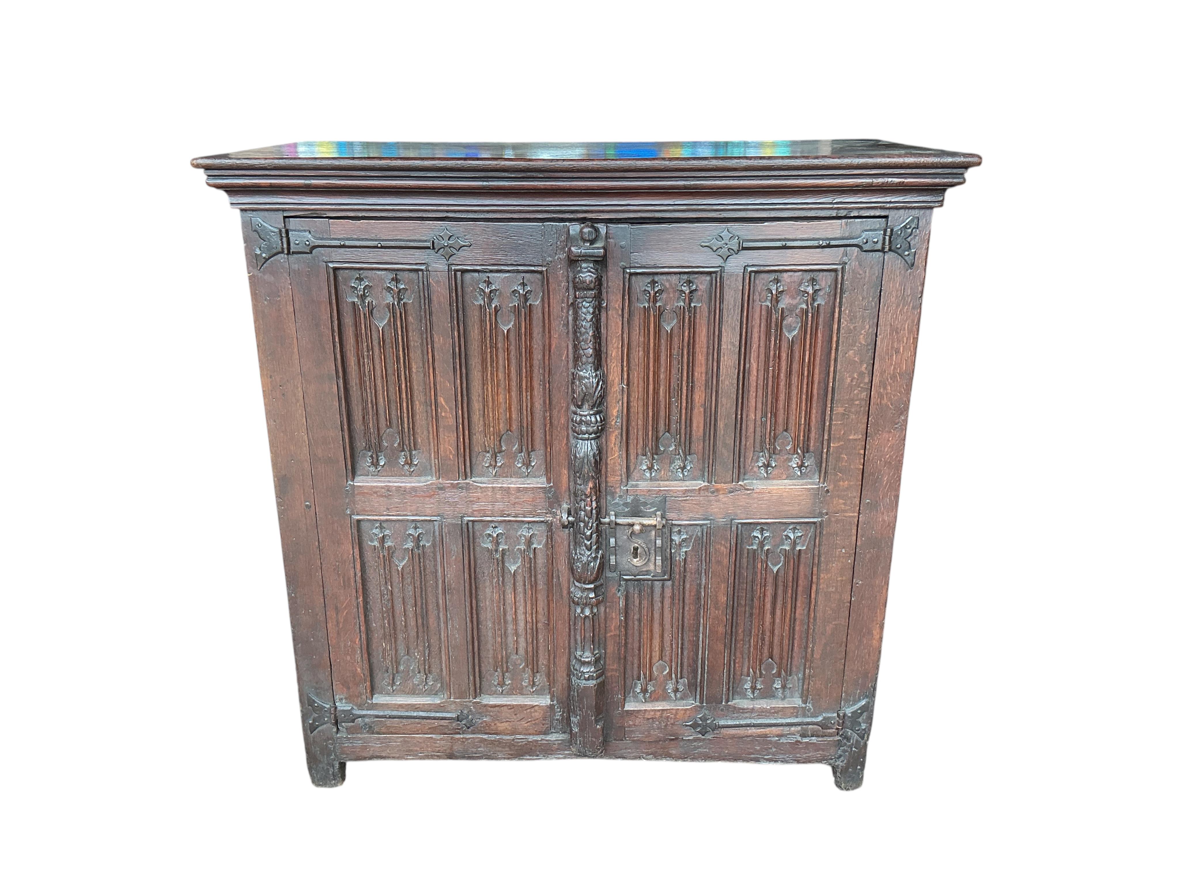 An 18th century and later French carved oak two door cabinet, width 115cm, depth 53cm, height 115cm